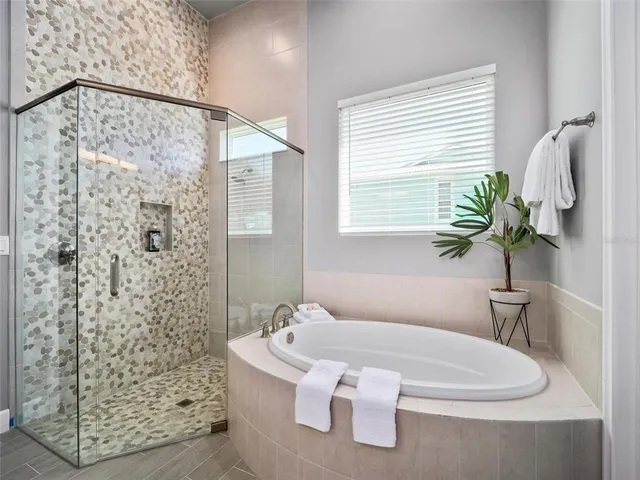 a bathroom with a bathtub and shower