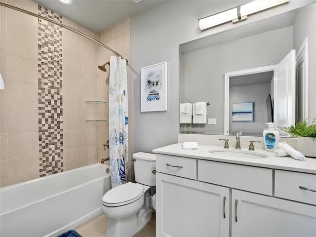 a bathroom with a double vanity sink toilet mirror and shower