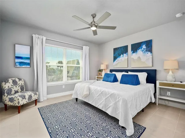 a bedroom with a large bed and a window