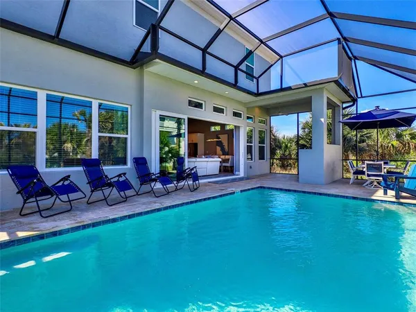 a view of a backyard with a patio and dining space
