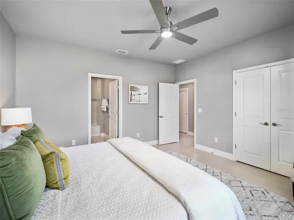 a bedroom with a large bed and a chandelier