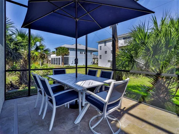 a patio with a patio table and chairs