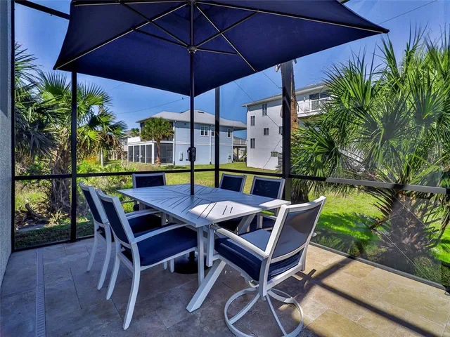 a patio with a patio table and chairs