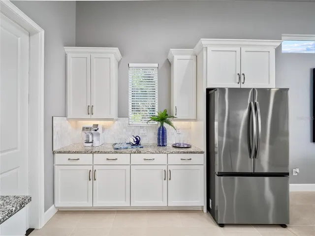 a kitchen with stainless steel appliances a refrigerator sink and cabinets