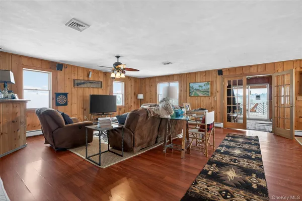 a kitchen with stainless steel appliances granite countertop a refrigerator a sink a stove a dining table and chairs