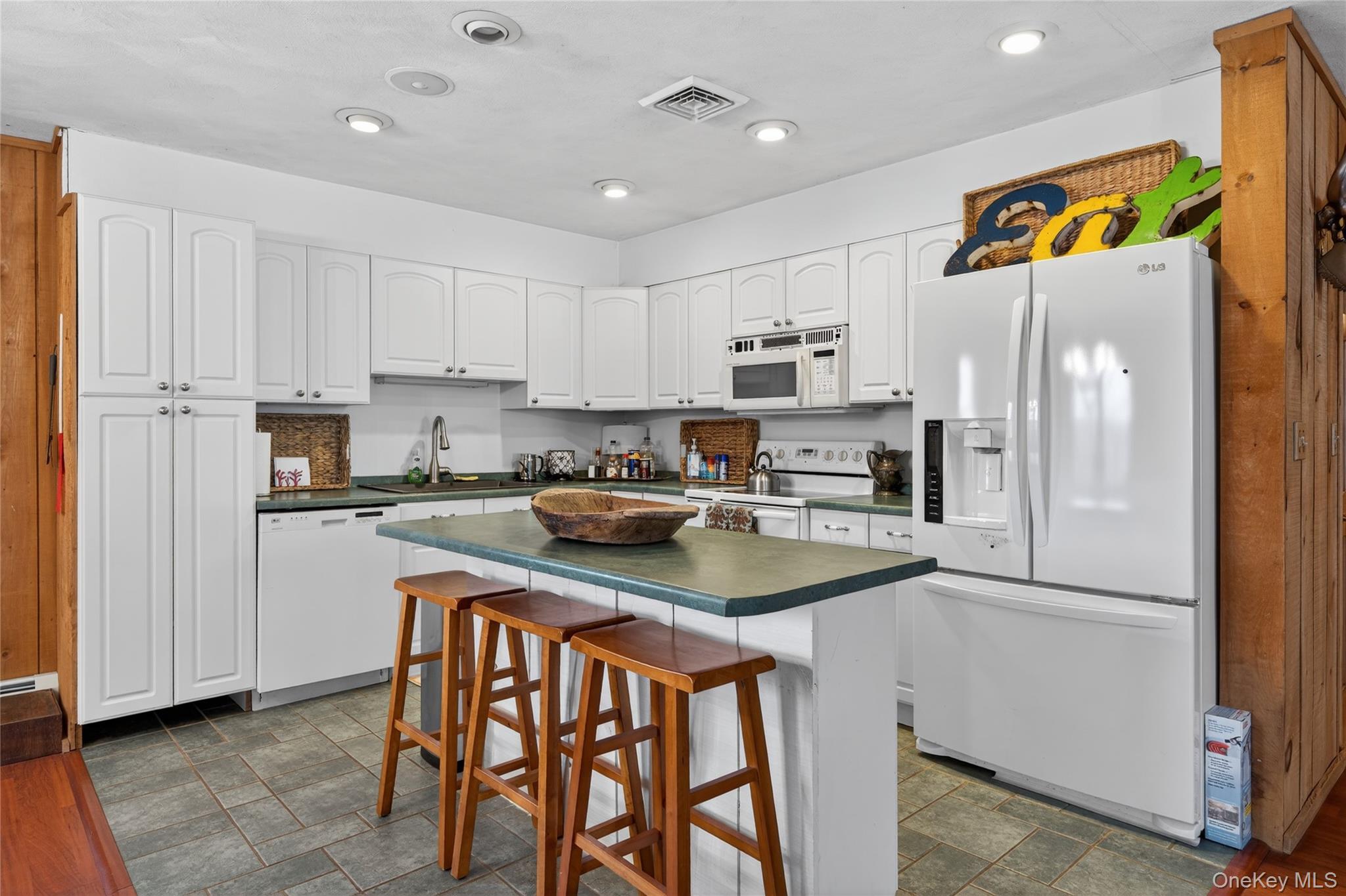 282 West Shore Road Bethel, NY 12783 - Photo 4 of 32 a kitchen with stainless steel appliances granite countertop a refrigerator a sink a stove a dining table and chairs