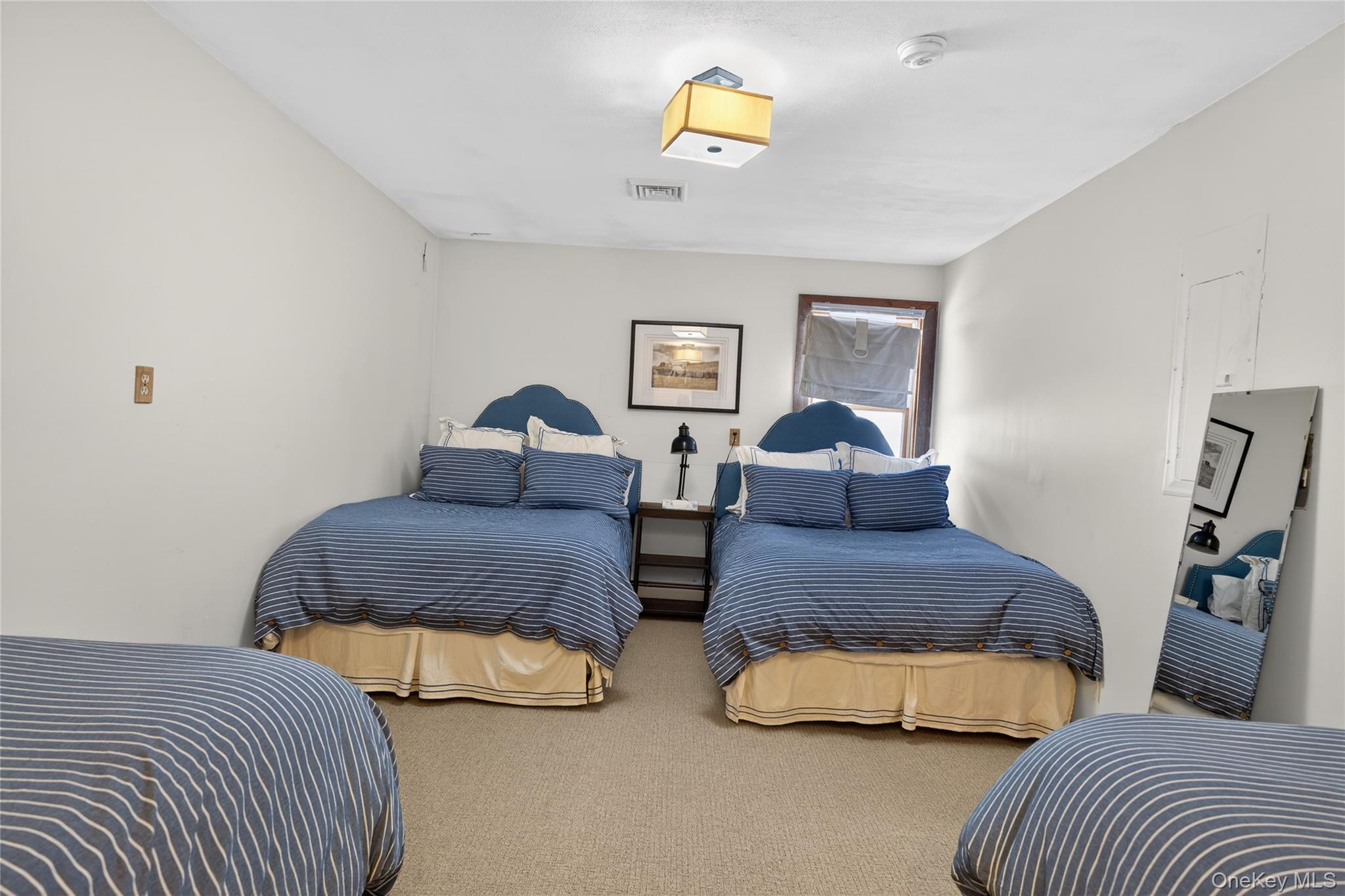 282 West Shore Road Bethel, NY 12783 - Photo 6 of 32 a bedroom with two beds and painting on the wall