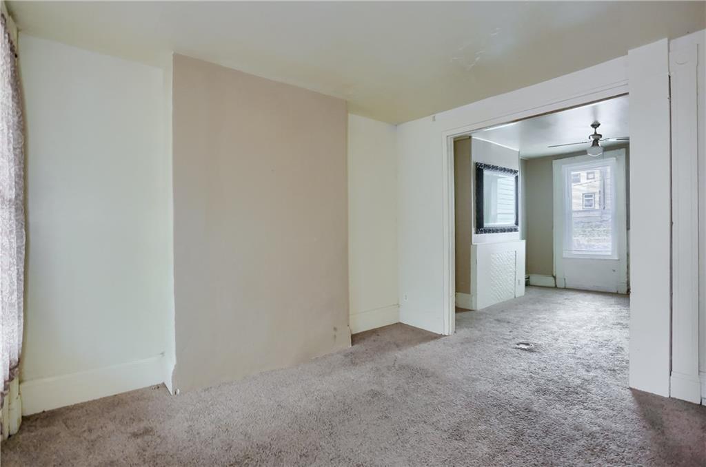 116 Hemlock Street Pittsburgh, PA 15212 - Photo 10 of 38 an empty room with closet and a bathroom