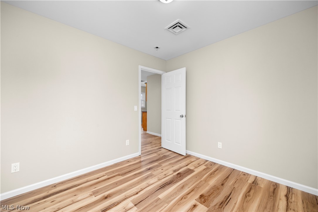 12452 Island Road Grafton, OH 44044 - Photo 22 of 39 Unfurnished room featuring light wood-style floors and baseboards