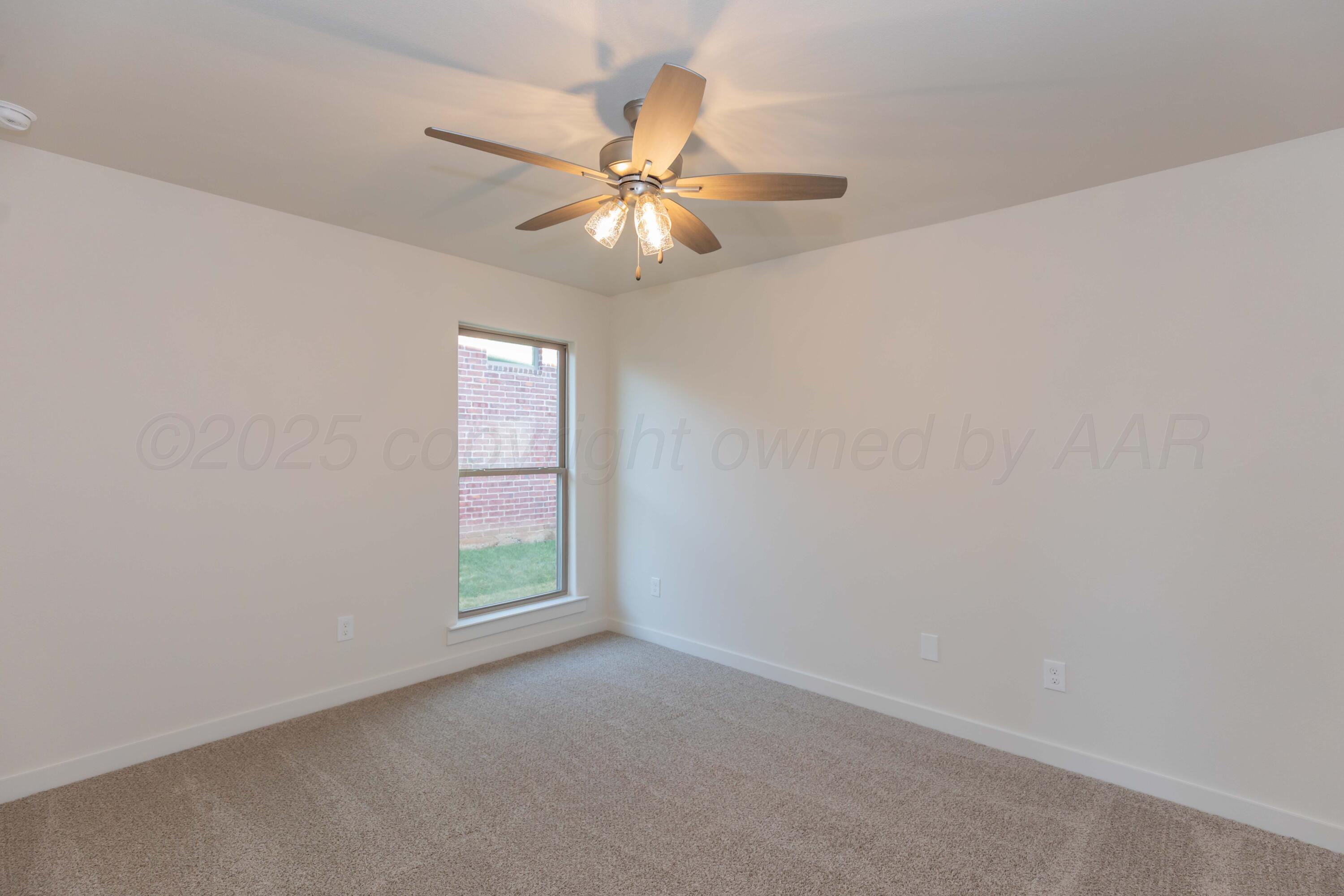 7601 Castleman Road Amarillo, TX 79119 - Photo 13 of 25 an empty room with windows and fan