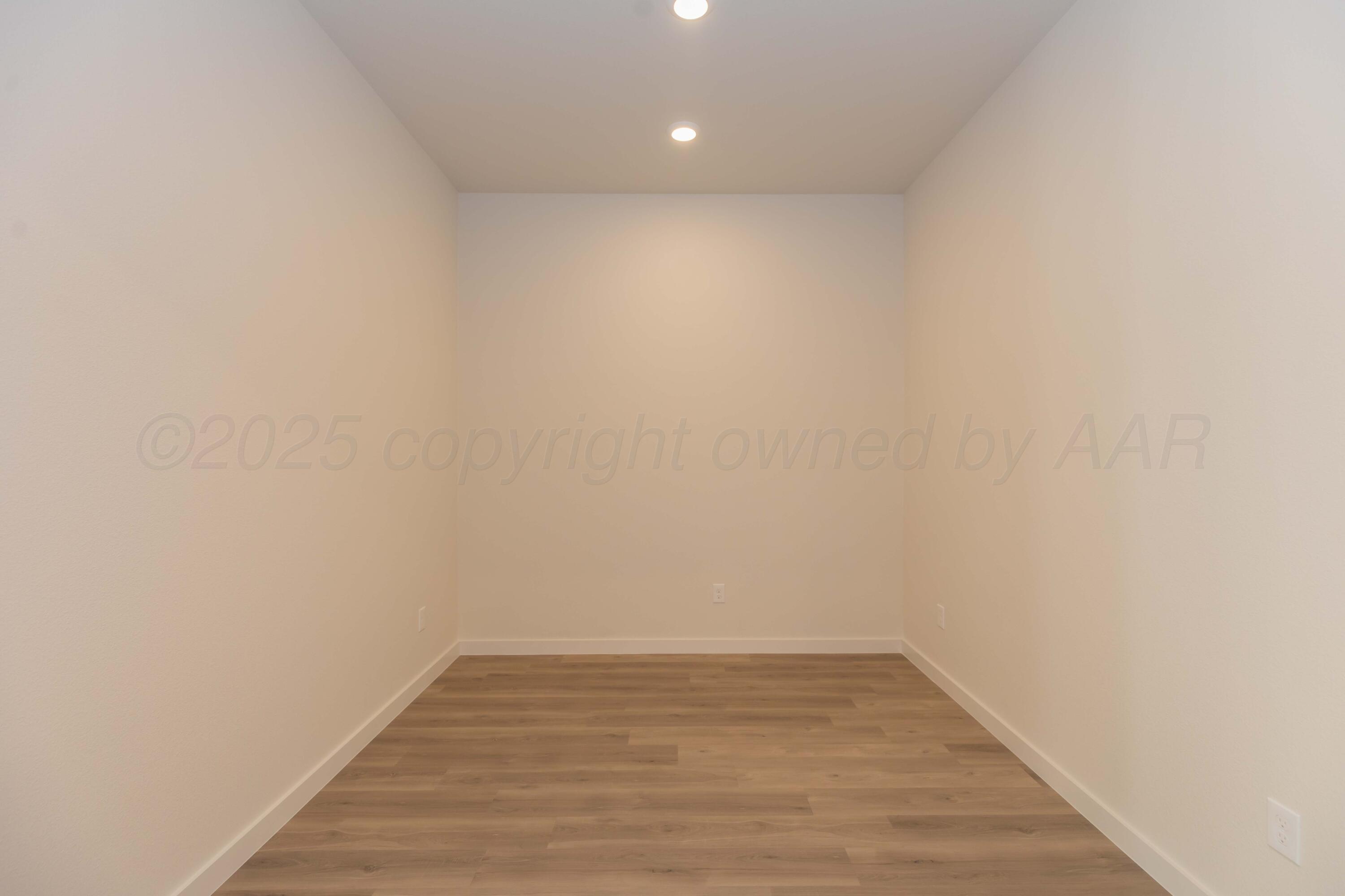 7601 Castleman Road Amarillo, TX 79119 - Photo 9 of 25 a view of an empty room with wooden floor