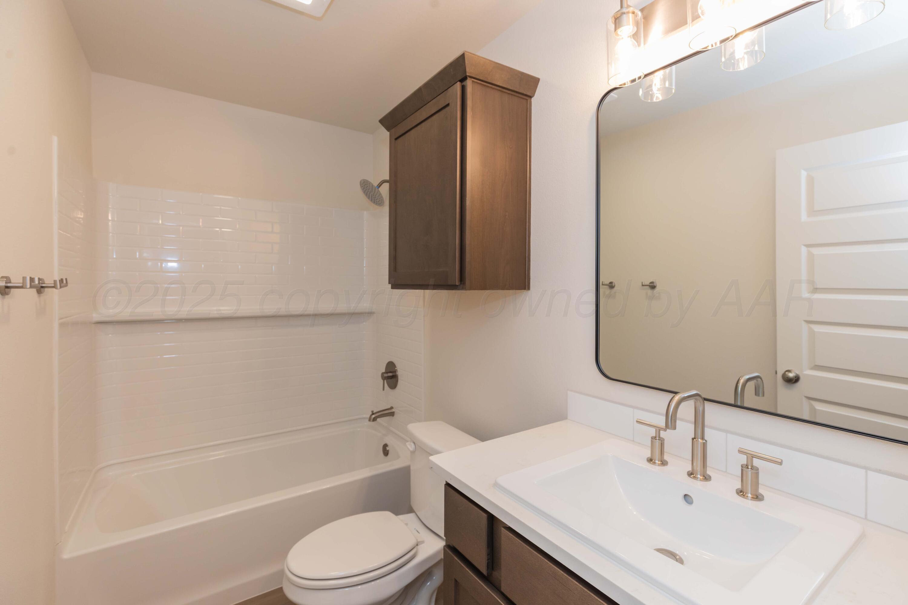 7601 Castleman Road Amarillo, TX 79119 - Photo 10 of 25 a bathroom with a sink a toilet and shower