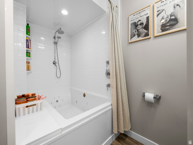 7 Sterling Loop Vineyard, UT 84059 - Photo 35 of 43 White subway tile shower surround with integrated shelving and a built-in jetted tub featuring a rain showerhead and handheld sprayer