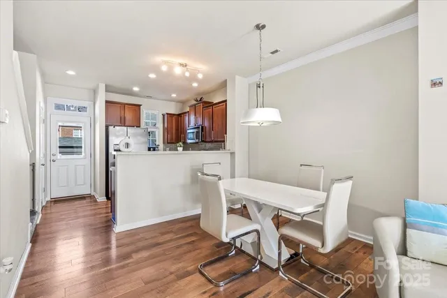 a view of kitchen with refrigerator and wooden floor