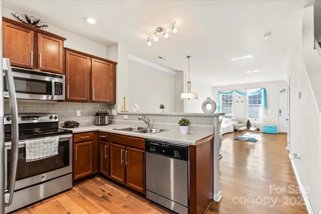a kitchen with a sink stove and cabinets