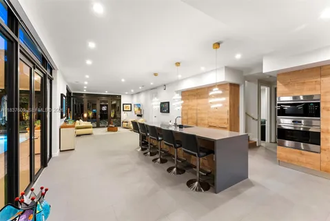 a living room with furniture and large windows