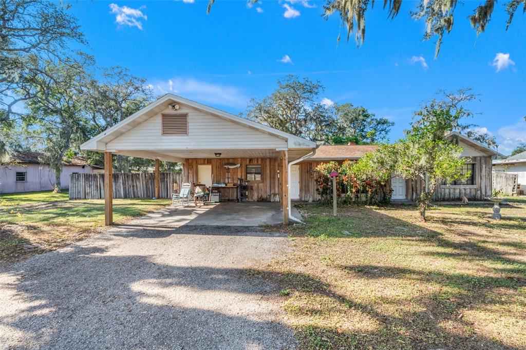 a view of a house with a yard and sitting area