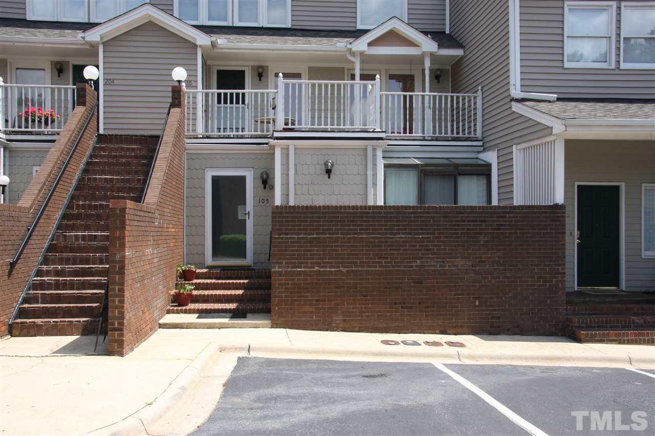 7040 Sandy Forks Road, Unit 105 Raleigh, NC 27615 - Photo 1 of 21 a front view of a house with a yard