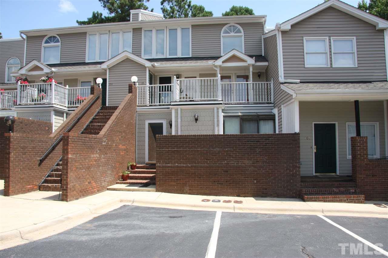 7040 Sandy Forks Road, Unit 105 Raleigh, NC 27615 - Photo 2 of 21 a front view of a house with a yard