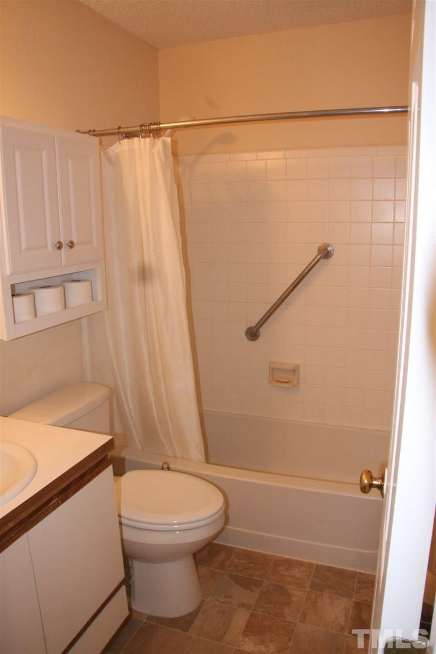 7040 Sandy Forks Road, Unit 105 Raleigh, NC 27615 - Photo 11 of 21 a bathroom with a toilet and a shower