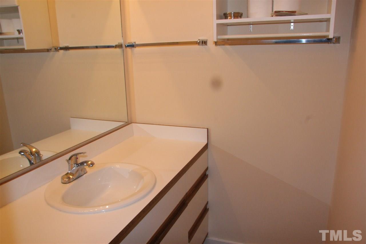 7040 Sandy Forks Road, Unit 105 Raleigh, NC 27615 - Photo 15 of 21 a bathroom with a sink and a white floor