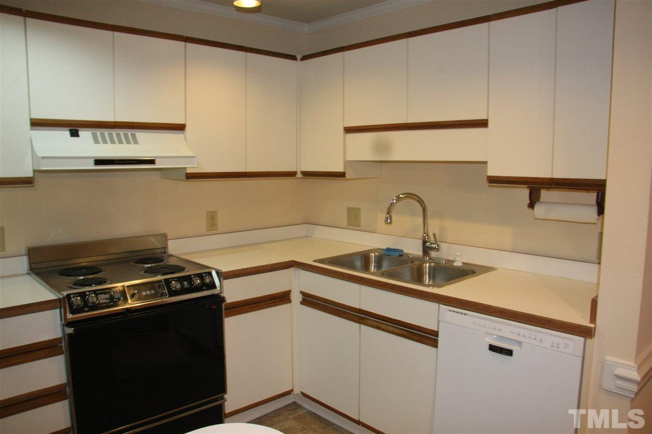 7040 Sandy Forks Road, Unit 105 Raleigh, NC 27615 - Photo 4 of 21 a kitchen with stainless steel appliances a sink stove and cabinets