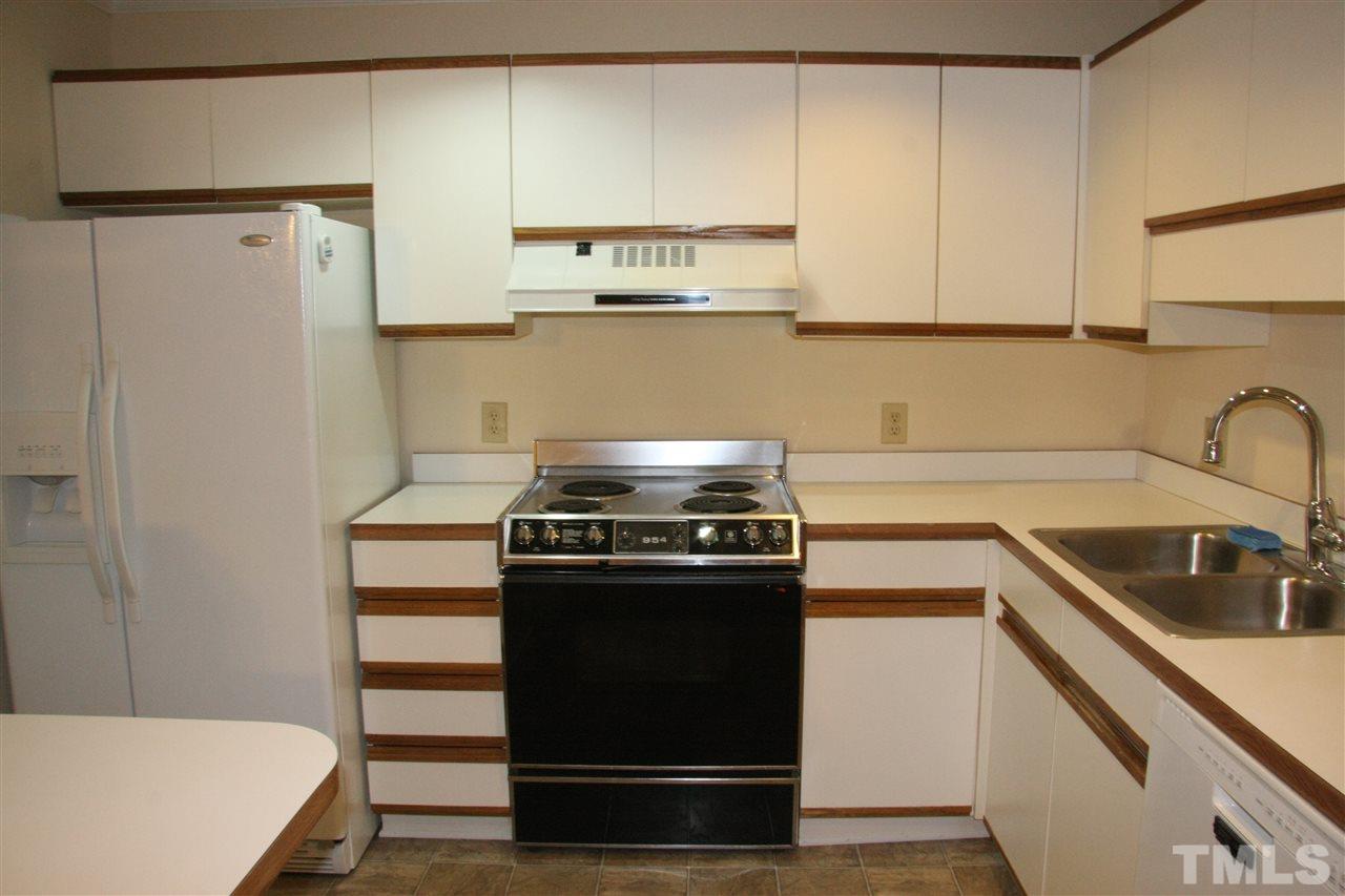 7040 Sandy Forks Road, Unit 105 Raleigh, NC 27615 - Photo 5 of 21 a kitchen with stainless steel appliances a stove and a refrigerator