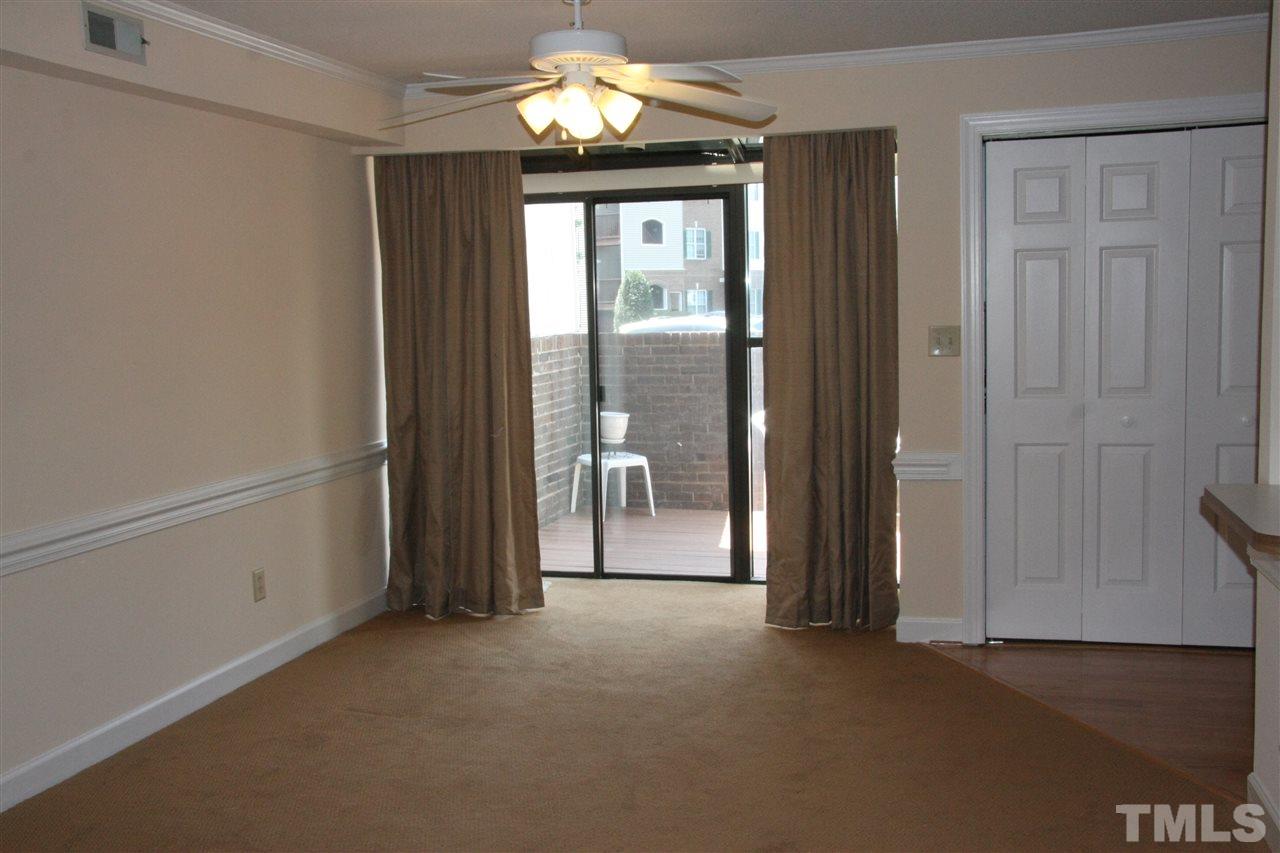 7040 Sandy Forks Road, Unit 105 Raleigh, NC 27615 - Photo 7 of 21 wooden floor in an empty room with a window