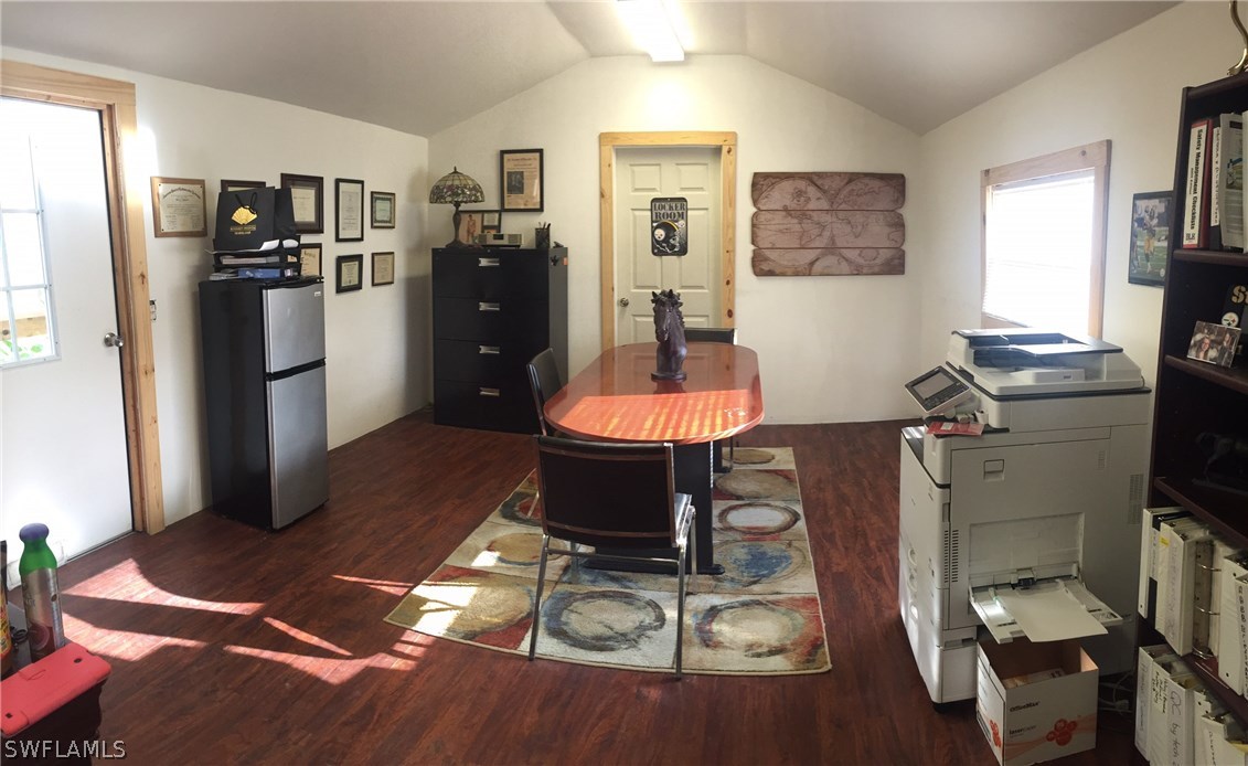 18900 South River Road Alva, FL 33920 - Photo 4 of 15 a living room with furniture a flat screen tv and a dining table