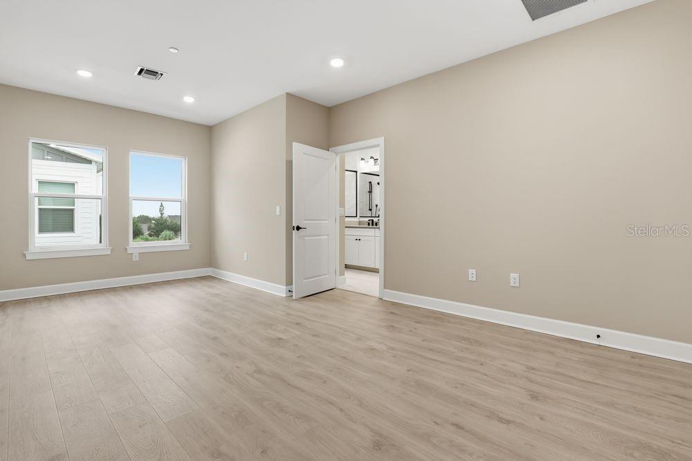 1624 Compass Pointe Court, Unit 203 Punta Gorda, FL 33950 - Photo 12 of 44 an empty room with wooden floor and windows