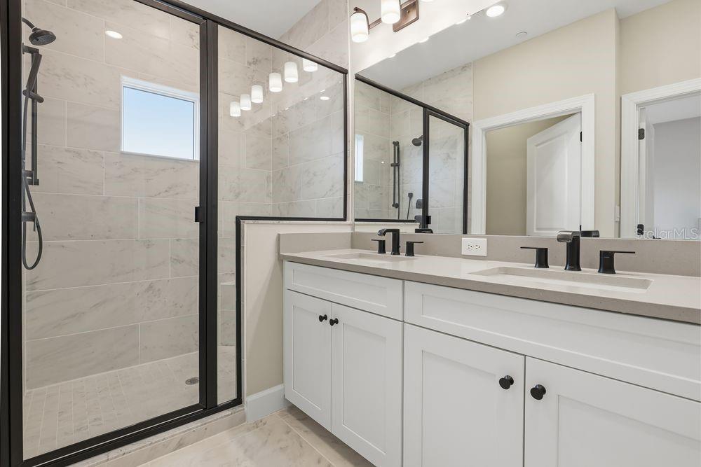 1624 Compass Pointe Court, Unit 203 Punta Gorda, FL 33950 - Photo 16 of 44 a bathroom with a double vanity sink and mirror