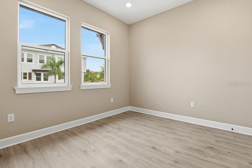 1624 Compass Pointe Court, Unit 203 Punta Gorda, FL 33950 - Photo 20 of 44 a view of an empty room with wooden floor and a window