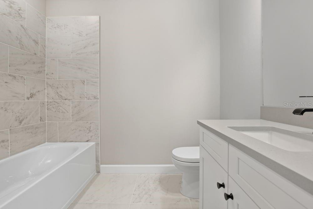 1624 Compass Pointe Court, Unit 203 Punta Gorda, FL 33950 - Photo 24 of 44 a bathroom with a sink a toilet and bathtub