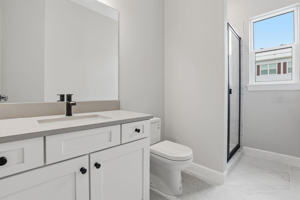 1624 Compass Pointe Court, Unit 203 Punta Gorda, FL 33950 - Photo 25 of 44 a bathroom with a sink a toilet and a mirror