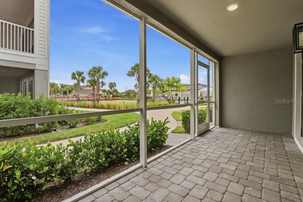 1624 Compass Pointe Court, Unit 203 Punta Gorda, FL 33950 - Photo 27 of 44 a view of porch with a bench in front of house