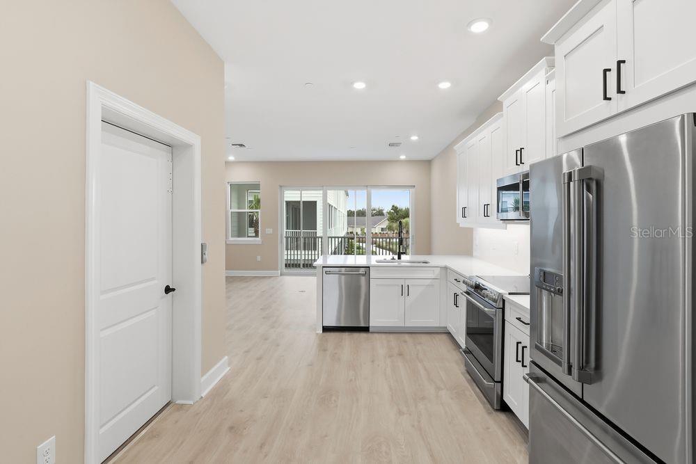 1624 Compass Pointe Court, Unit 203 Punta Gorda, FL 33950 - Photo 3 of 44 a kitchen with a refrigerator a sink and dishwasher