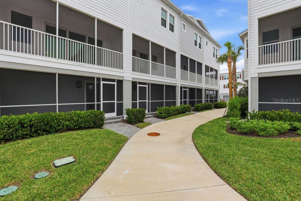 1624 Compass Pointe Court, Unit 203 Punta Gorda, FL 33950 - Photo 31 of 44 a front view of a house with a yard