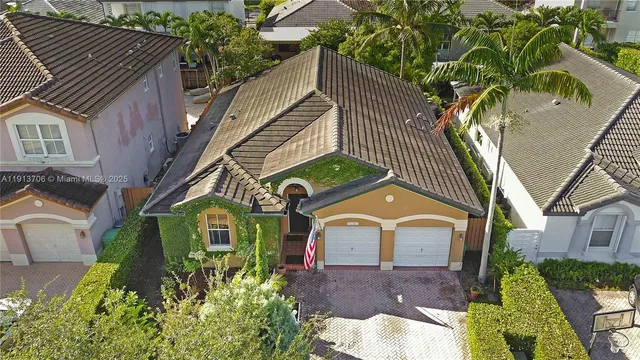 a view of a house with a yard and plants
