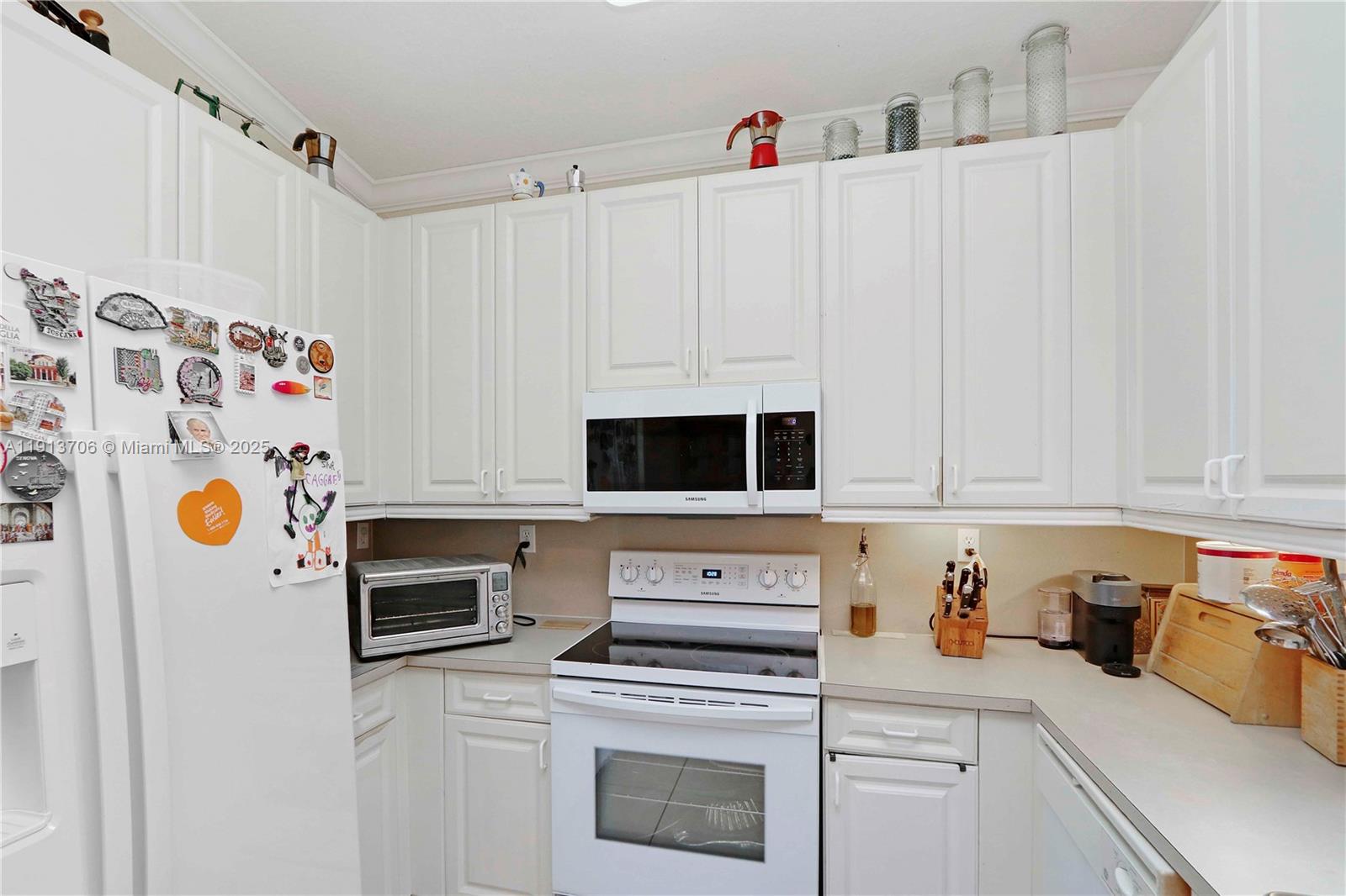 15382 Southwest 16th Terrace Miami, FL 33185 - Photo 7 of 26 a kitchen with stainless steel appliances a stove a microwave and a refrigerator