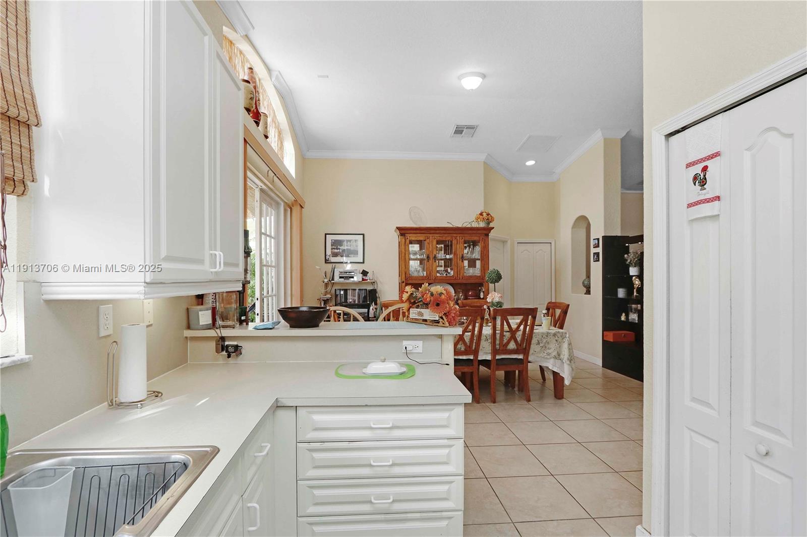 15382 Southwest 16th Terrace Miami, FL 33185 - Photo 10 of 26 a kitchen with a sink cabinets and window