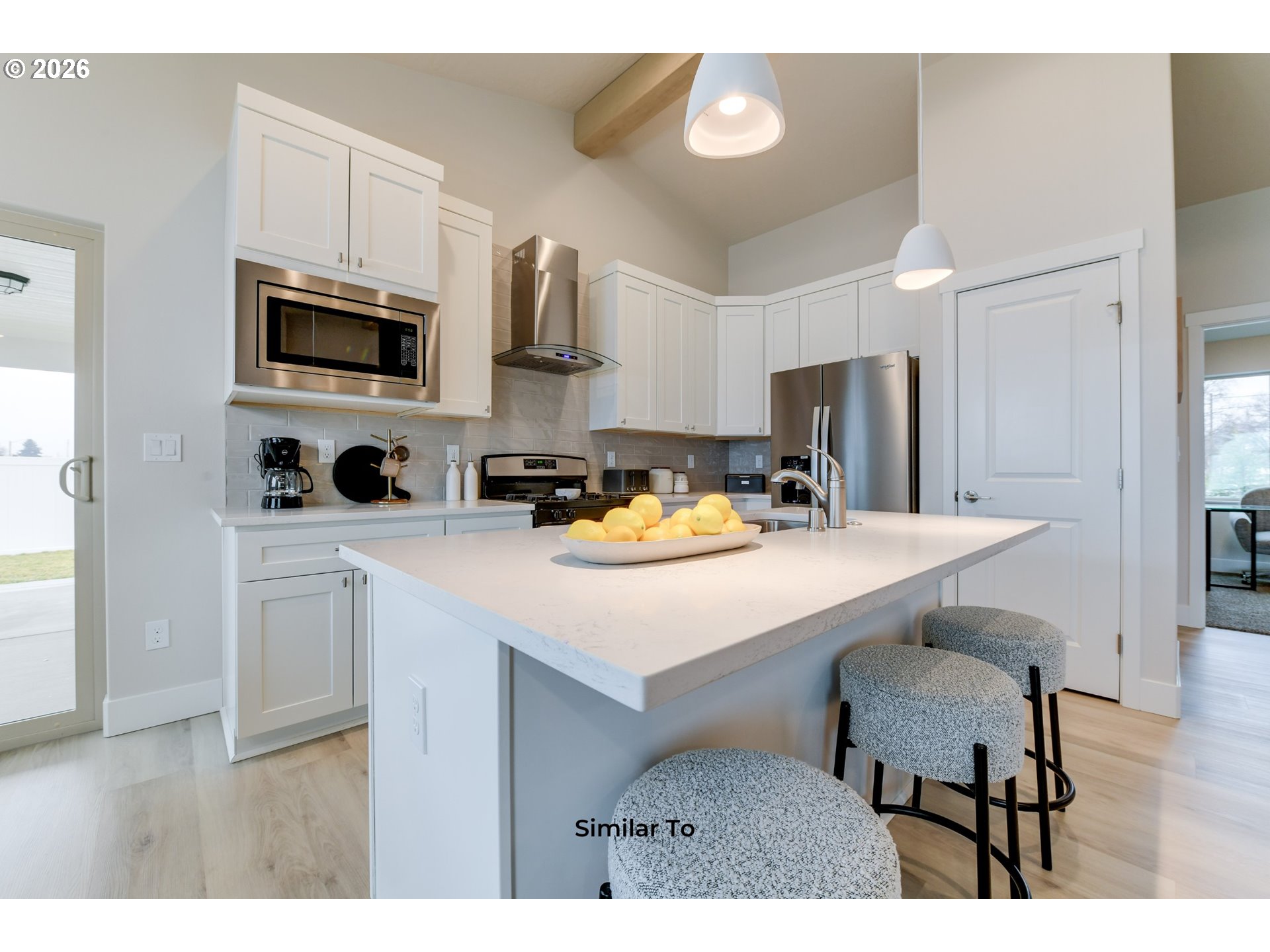 227 Southwest Goldfinch Lane Boardman, OR 97818 - Photo 7 of 28 a kitchen with stainless steel appliances a sink a microwave a refrigerator and cabinets