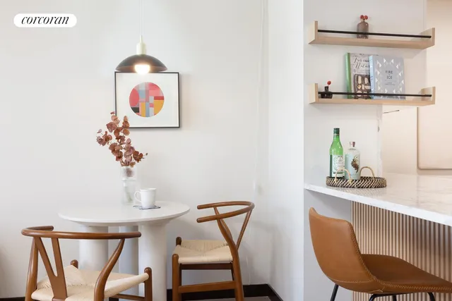 a living room with furniture and kitchen view