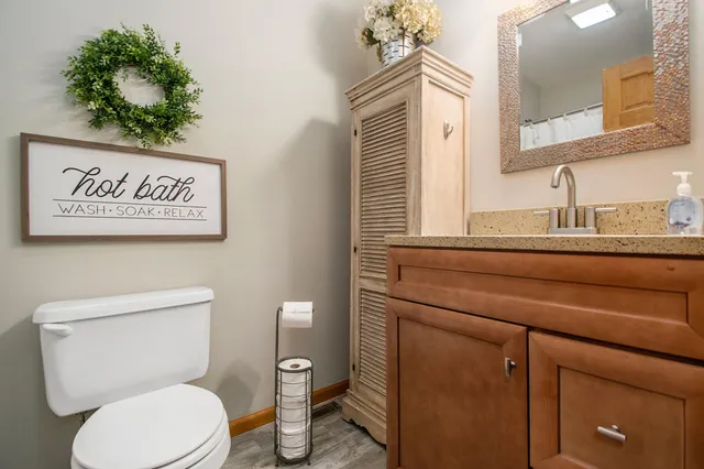 a bathroom with a toilet sink and mirror