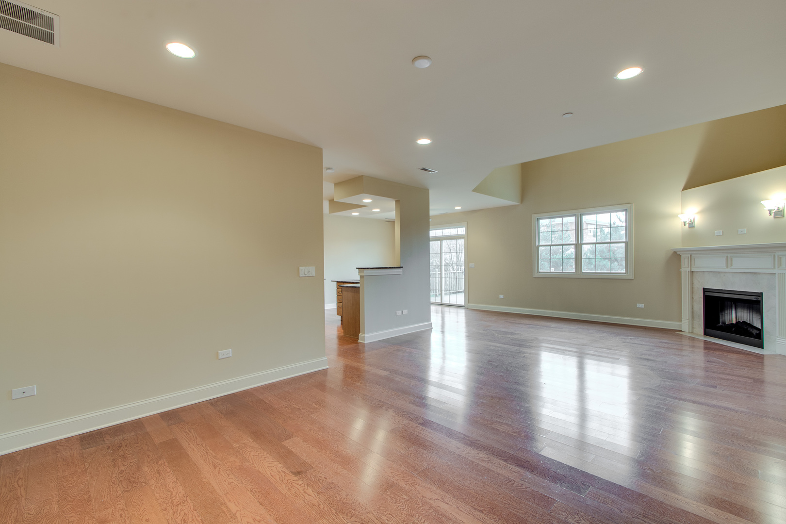 8705 Covington Place Justice, IL 60458 - Photo 2 of 30 a view of an empty room with window and wooden floor