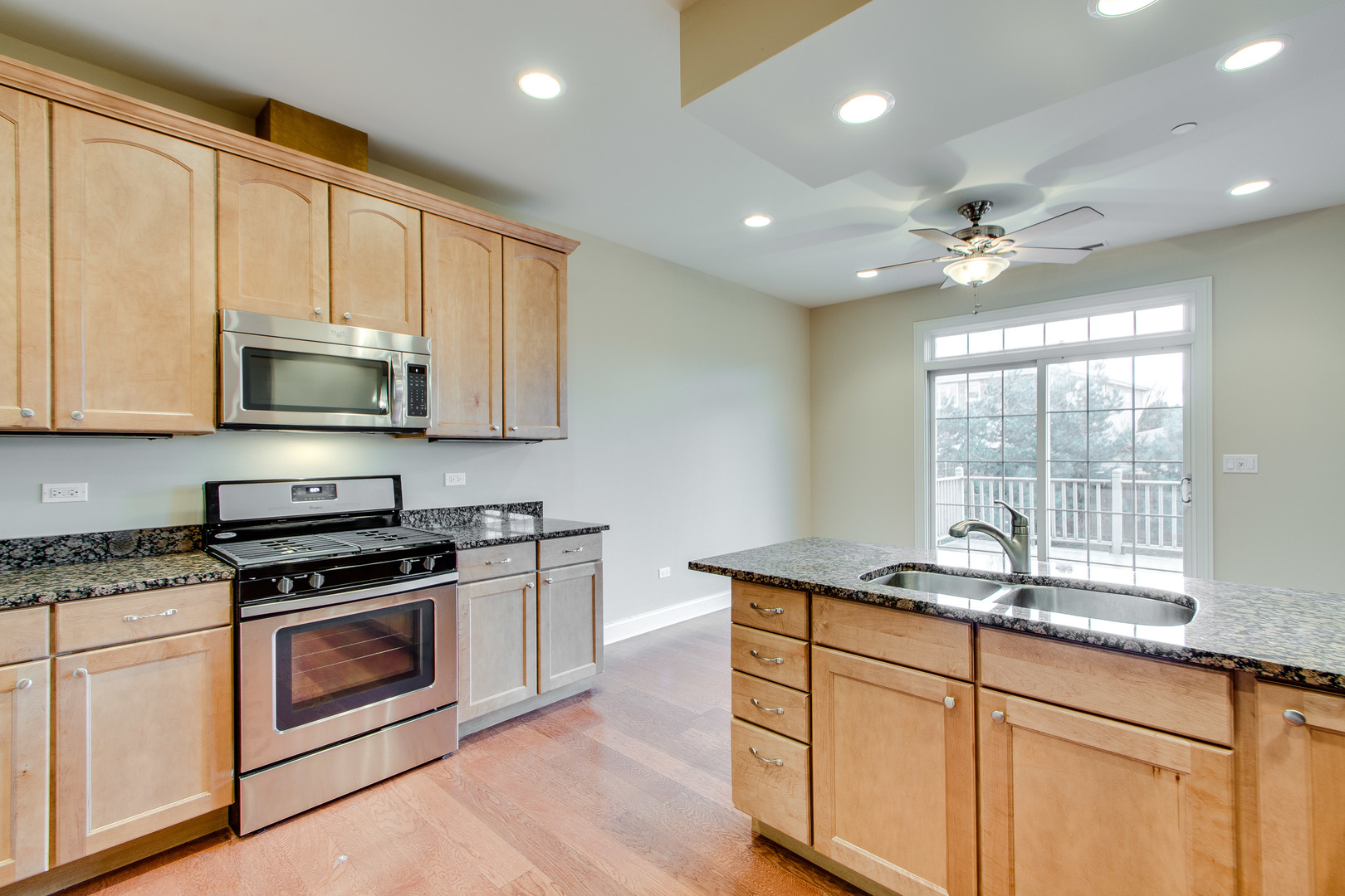 8705 Covington Place Justice, IL 60458 - Photo 11 of 30 a kitchen with stainless steel appliances granite countertop a stove a sink and a microwave