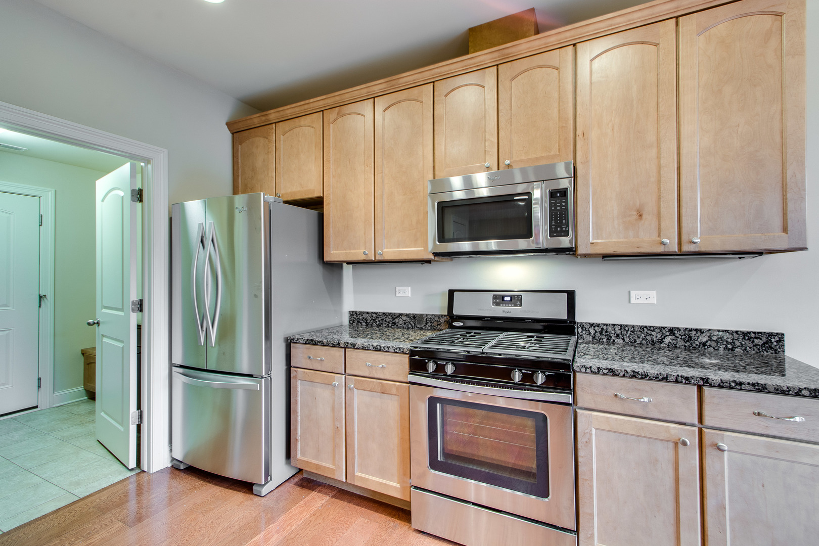 8705 Covington Place Justice, IL 60458 - Photo 12 of 30 a kitchen with stainless steel appliances granite countertop white cabinets and a stove top oven