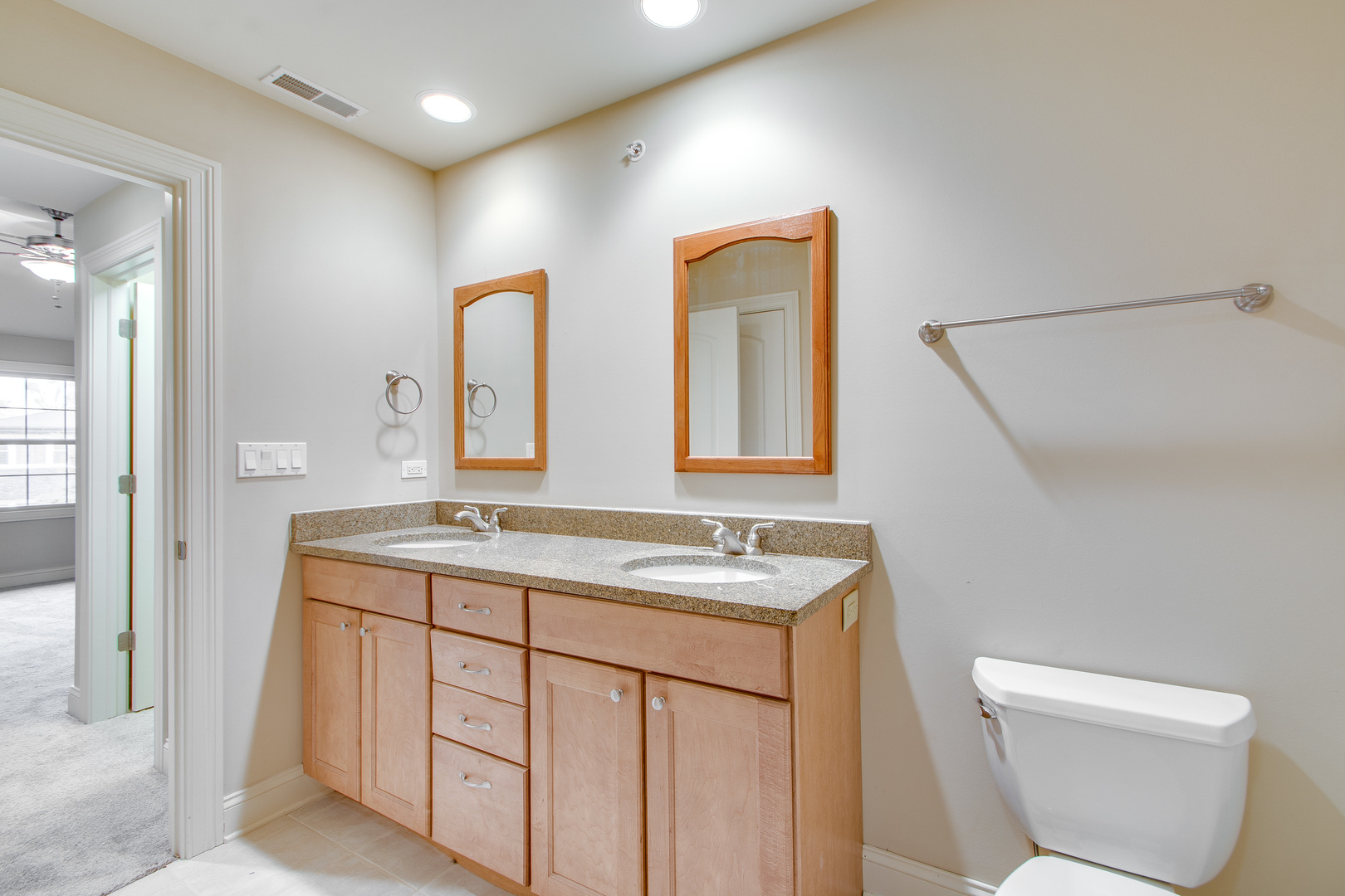 8705 Covington Place Justice, IL 60458 - Photo 20 of 30 a bathroom with a toilet sink and mirror