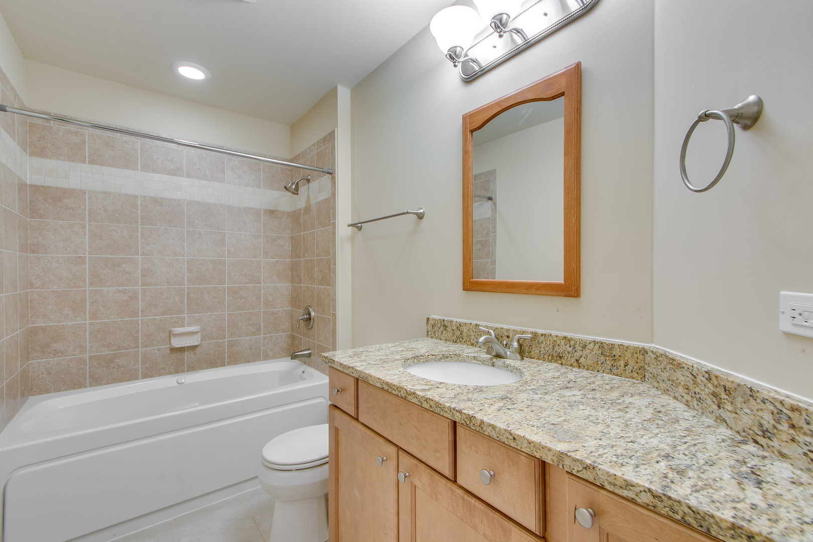 8705 Covington Place Justice, IL 60458 - Photo 22 of 30 a bathroom with a granite countertop sink a toilet and shower
