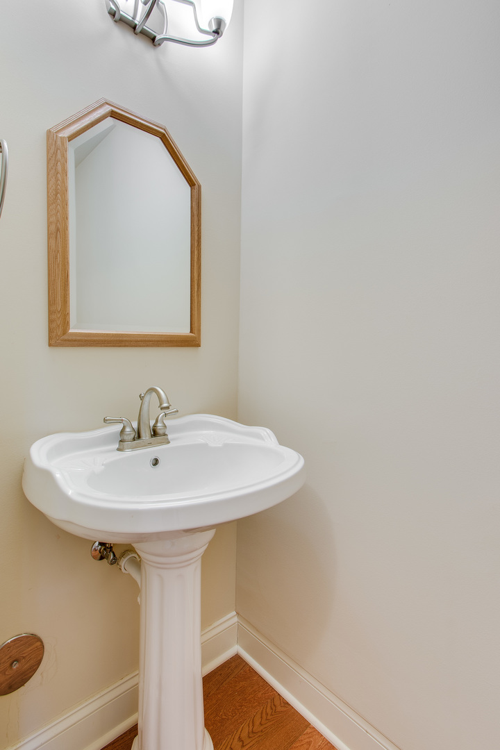 8705 Covington Place Justice, IL 60458 - Photo 23 of 30 a bathroom with a sink and a mirror