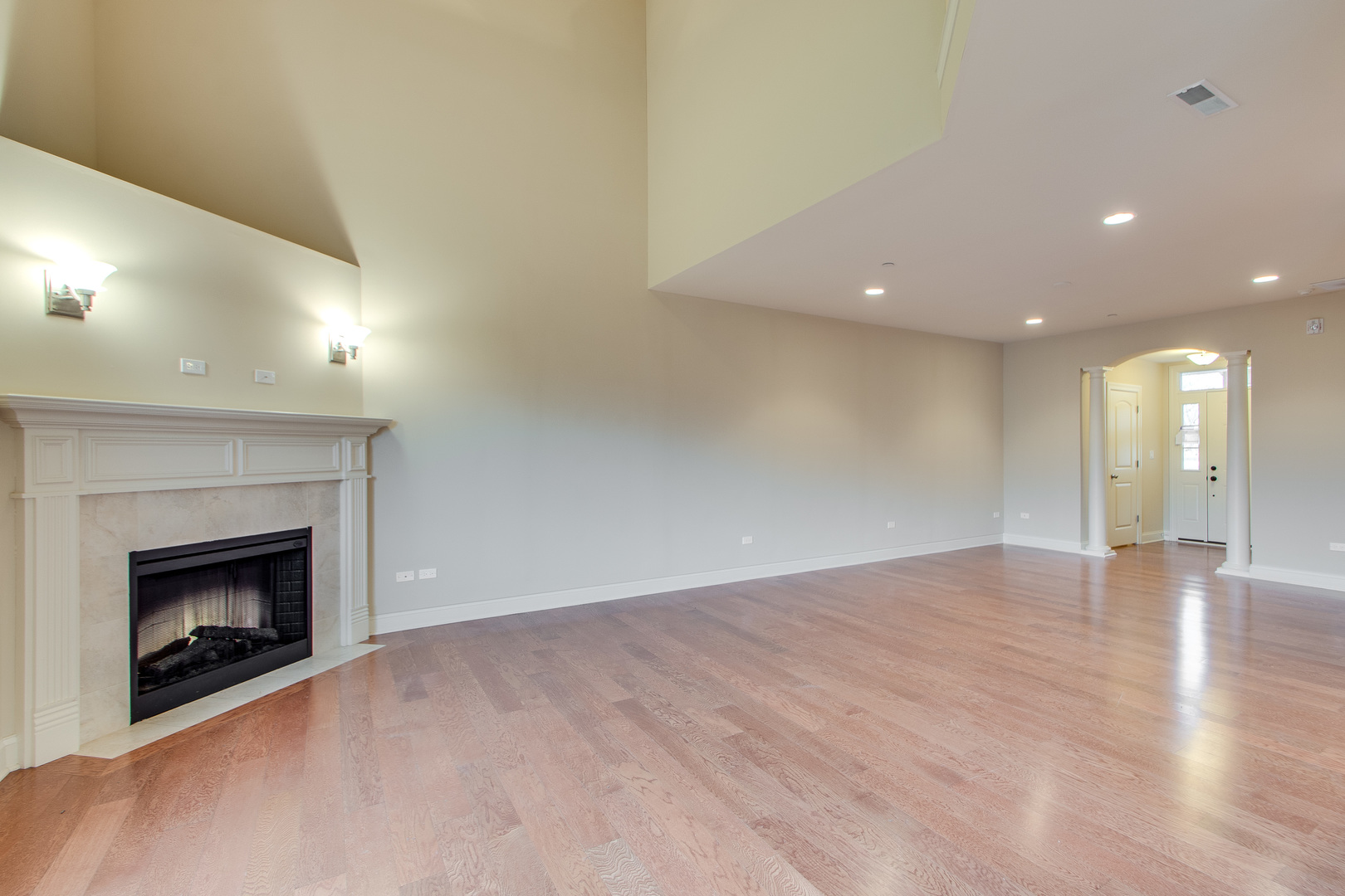 8705 Covington Place Justice, IL 60458 - Photo 4 of 30 a view of an empty room with wooden floor fireplace and a window